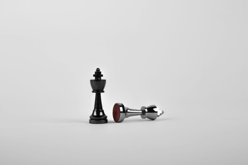 Web design strategy concept symbolised by chess king and fallen piece