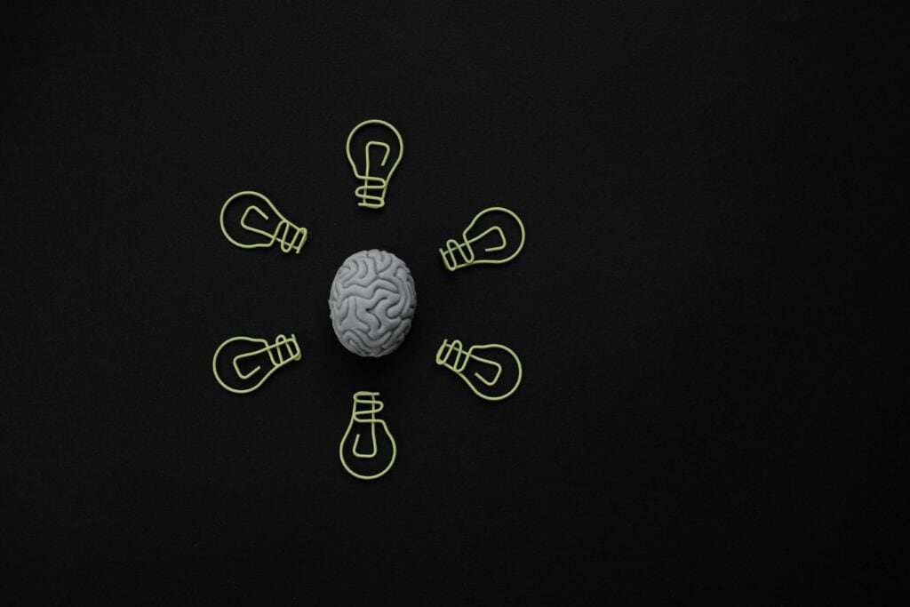 Brain with surrounding lightbulbs – concept of web design psychology, decision-making and user insight