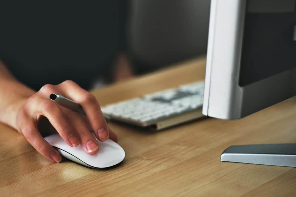 Person interacting with website on desktop computer – illustrating user behaviour and web design interaction